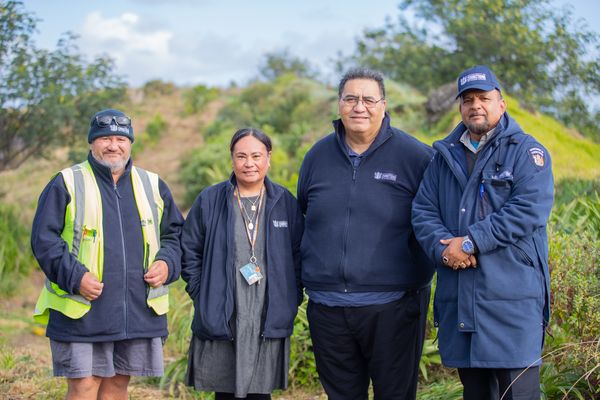 Community Work Supervisors and Probation Officers stand together with a park in the background