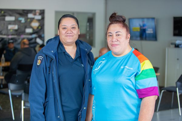 Two Senior Community Work Supervisors stand together smiling. 